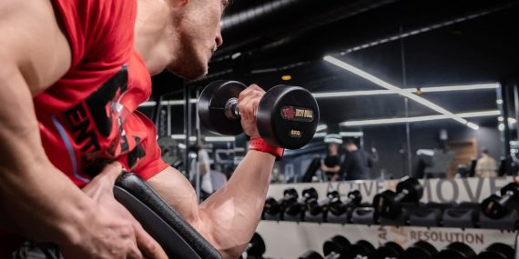 a man lifting a dumbbell in a gym